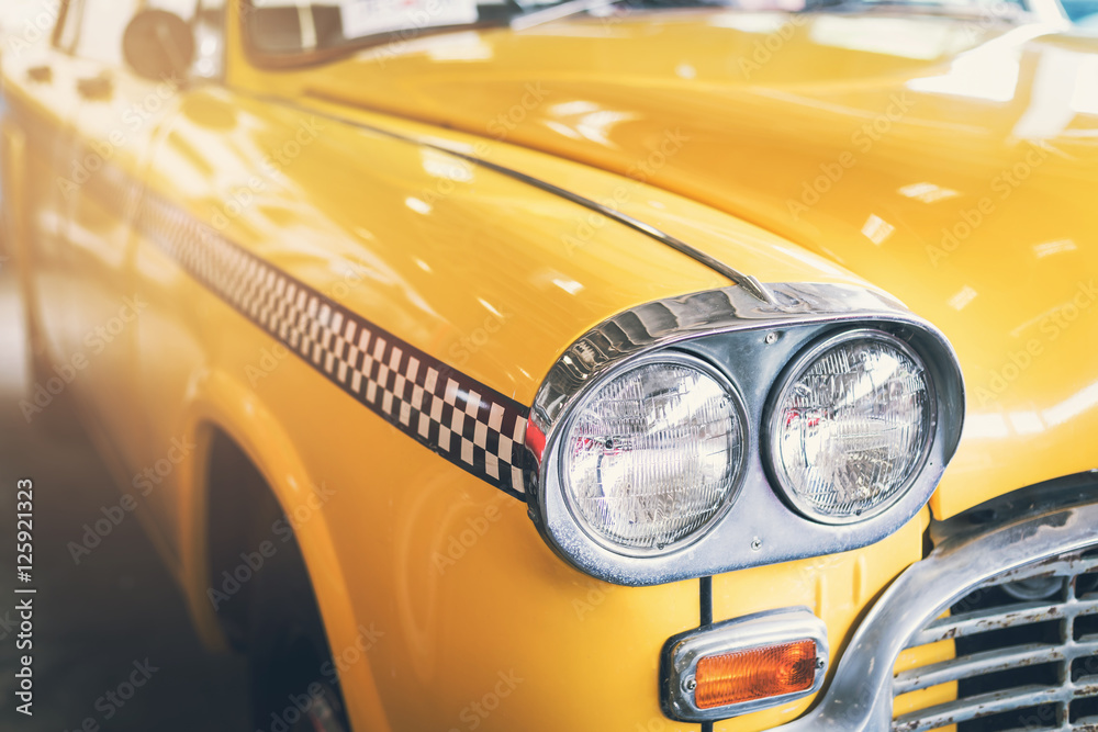 Fototapeta premium Close up headlight of yellow Retro classic car