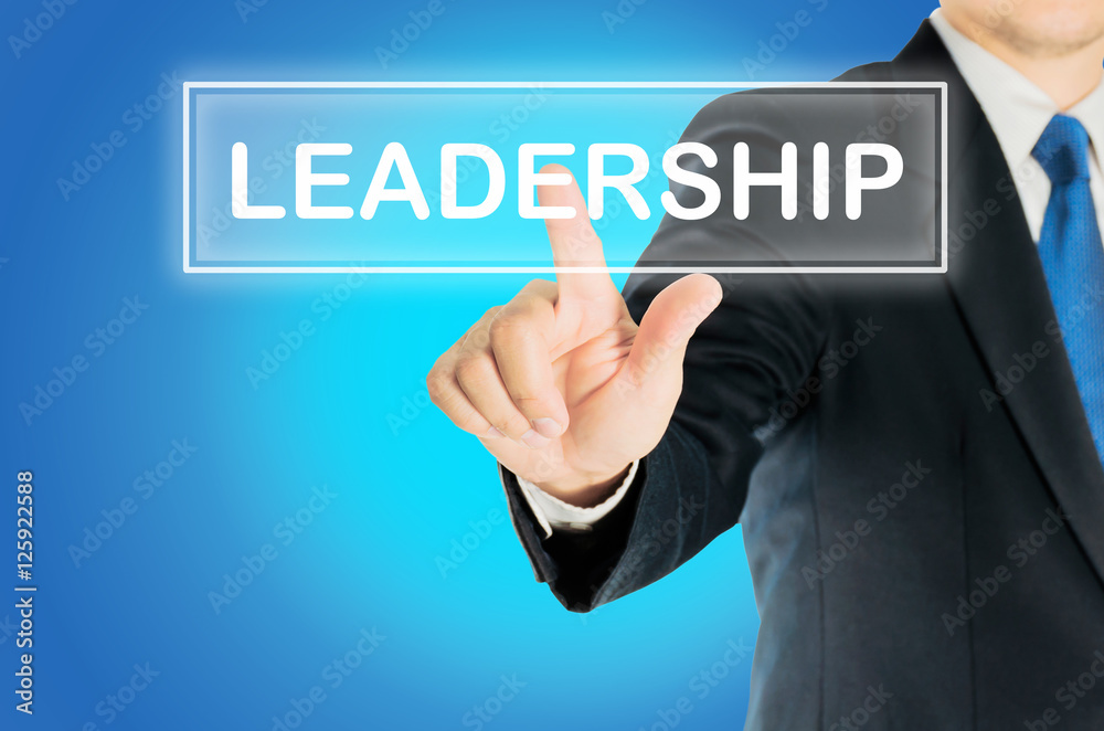Business man is pushing LEADERSHIP transparent button word over blue gradient background, business concept Business man is pushing LEADERSHIP transparent button word over blue gradient background, business concept