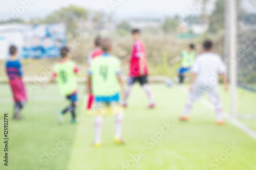 Blurred photo of children are practicing soccer in football field