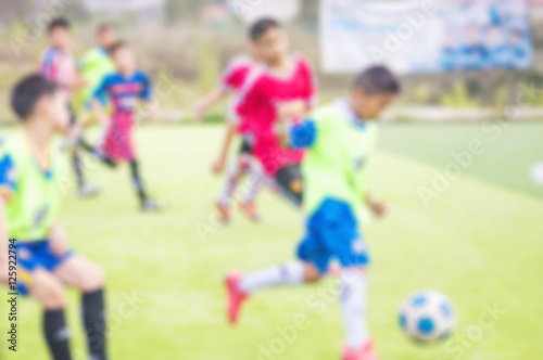 Fototapeta Naklejka Na Ścianę i Meble -  Blurred photo of children are practicing soccer in football field