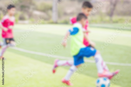 Blurred photo of children are practicing soccer in football field