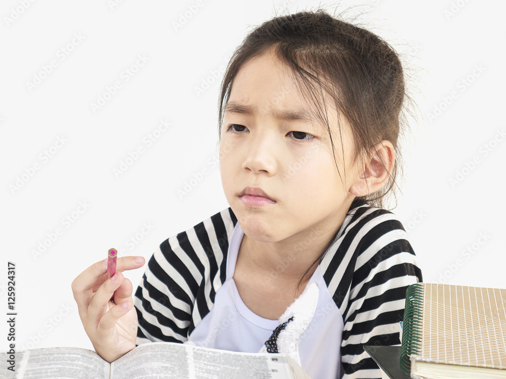 Asian kid is thinking while reading book Asian kid is thinking while reading book