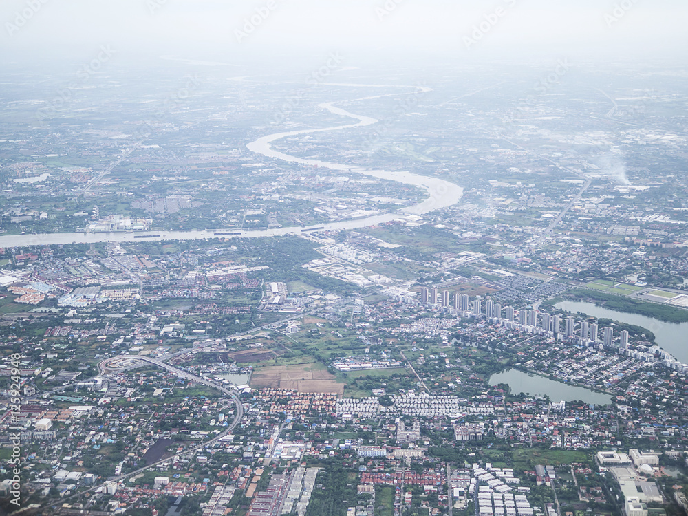 Soft focused of aerial view of Bangkok city and Chao Phraya river with morning fog overlay, capital of Thailand