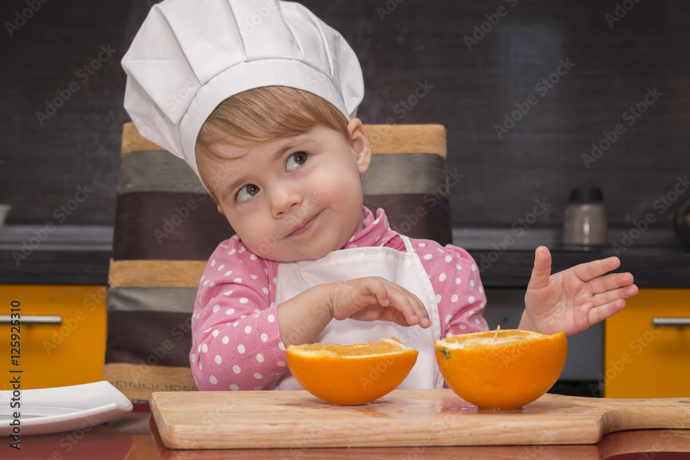 clouse-up portrait smile little cute girl in chef suit. Mother's helper. 2 year old. clouse-up portrait smile little cute girl in chef suit. Mother's helper. 2 year old.