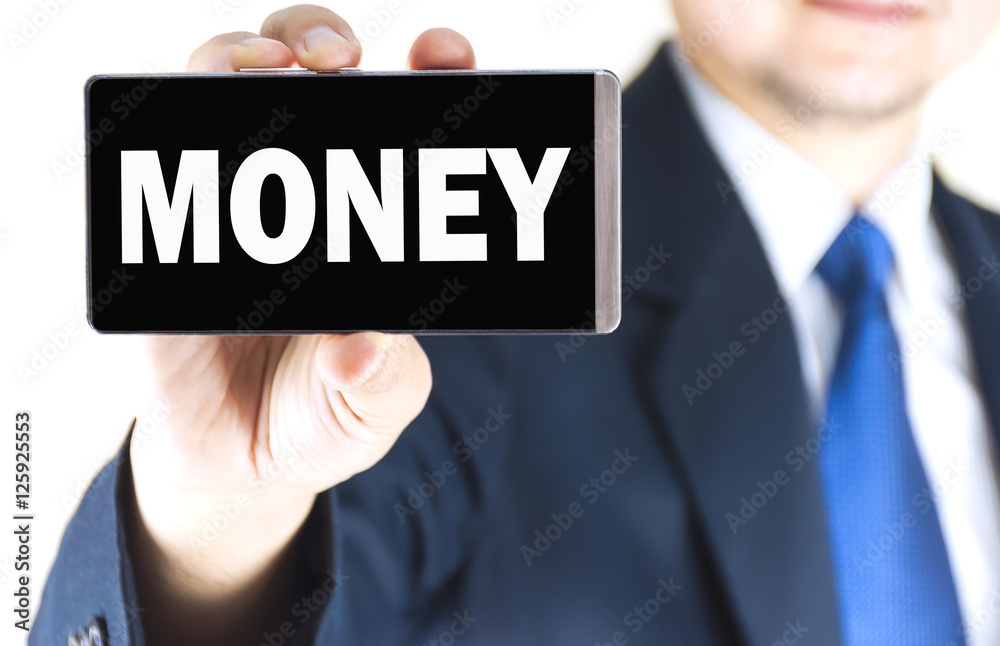 MONEY word on mobile phone screen in blurred young businessman hand over white background, business concept MONEY word on mobile phone screen in blurred young businessman hand over white background, business concept