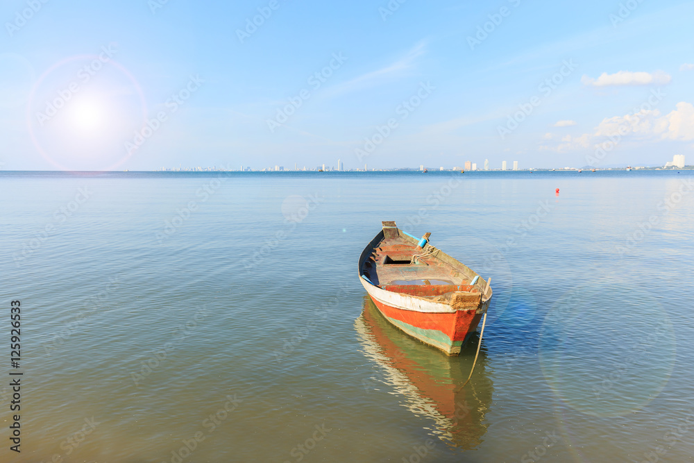 old wood fishing boat at anchor in sea