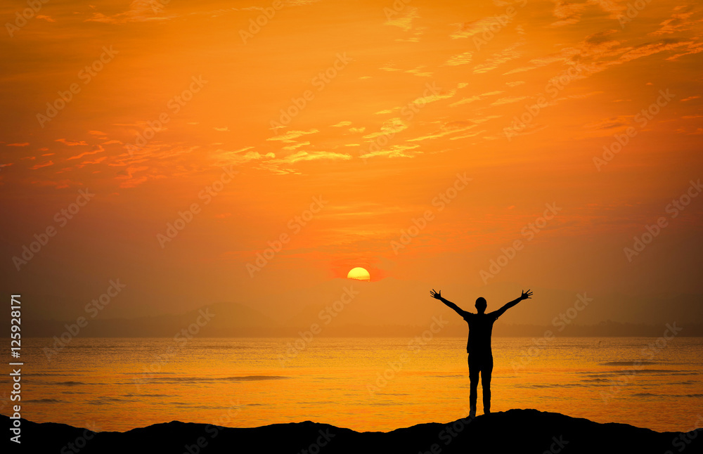 Landscapes image of Dramatic sunset over the sea with silhouette happy man on mountains Landscapes image of Dramatic sunset over the sea with silhouette happy man on mountains