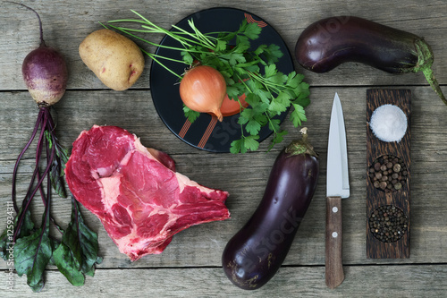 meat, vegetables and spices on a wooden table