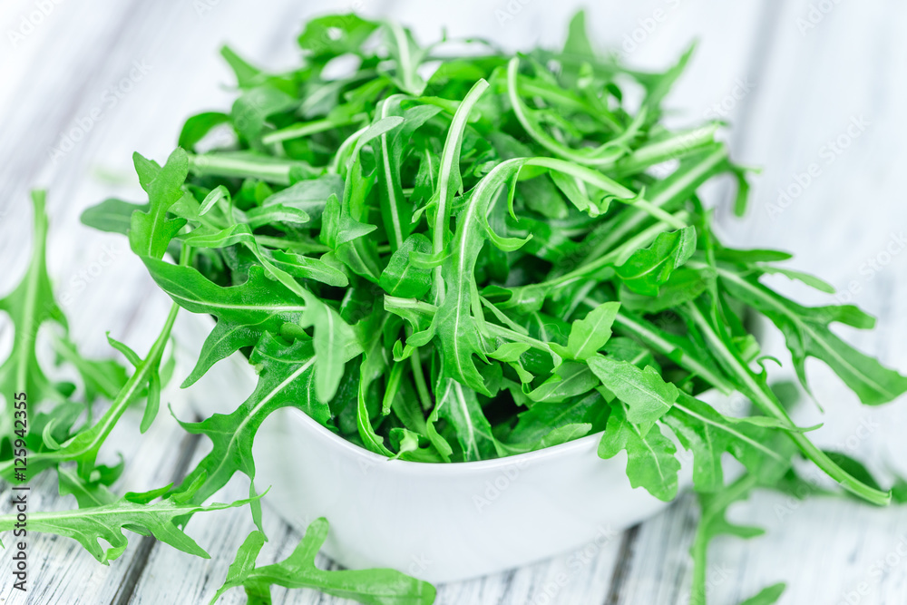 Wooden table with fresh Arugula Wooden table with fresh Arugula