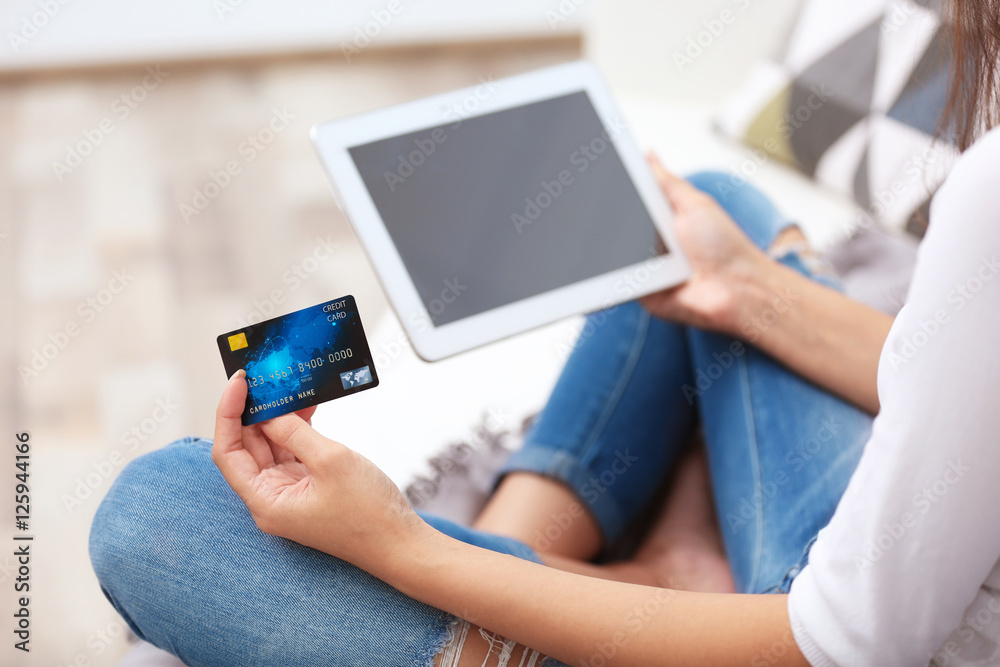 Woman with credit card and tablet making online shopping Woman with credit card and tablet making online shopping