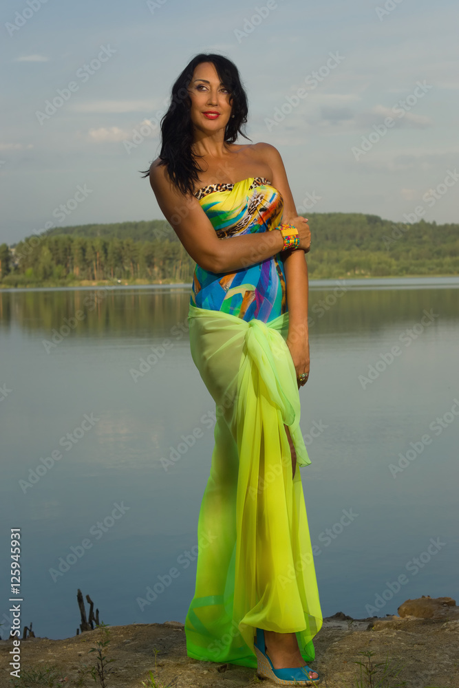 Beautiful adult woman in bikini and with pareo on the beach by t Beautiful adult woman in bikini and with pareo on the beach by t