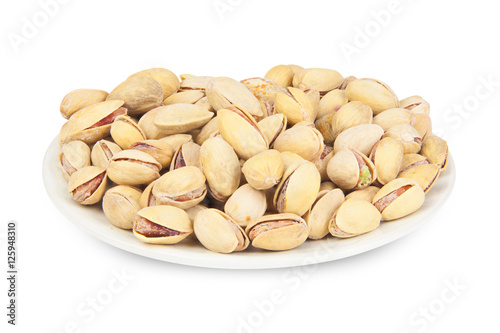delicious pistachio nuts on  plate on  white background