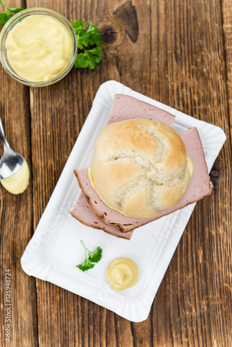 Portion of German Leberkaese on wooden background (selective foc photo