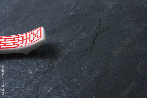 Red chopsticks on stone slate © QuinVa Stock
