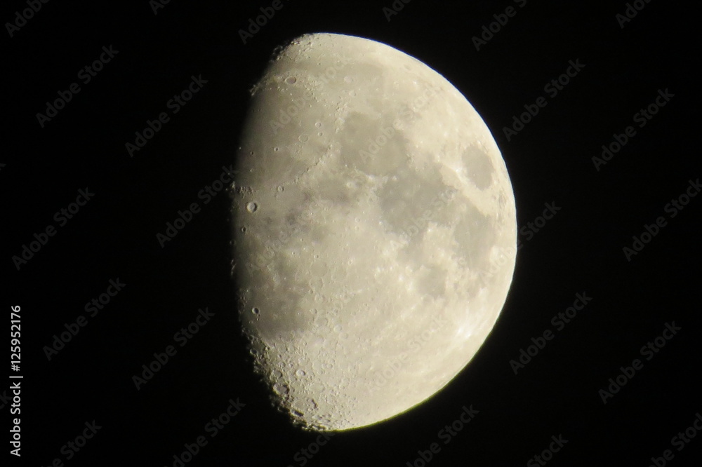 Partial gibbous moon with visible craters in a dark night. Partial gibbous moon with visible craters in a dark night.