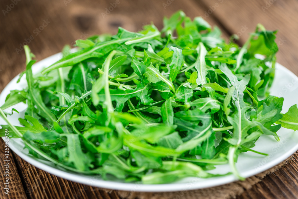 Fresh Arugula on an old wooden table Fresh Arugula on an old wooden table