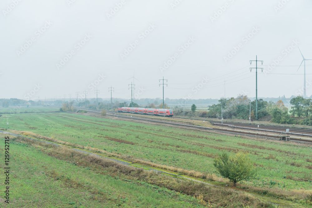 Short passenger train travelling through farmland Short passenger train travelling through farmland