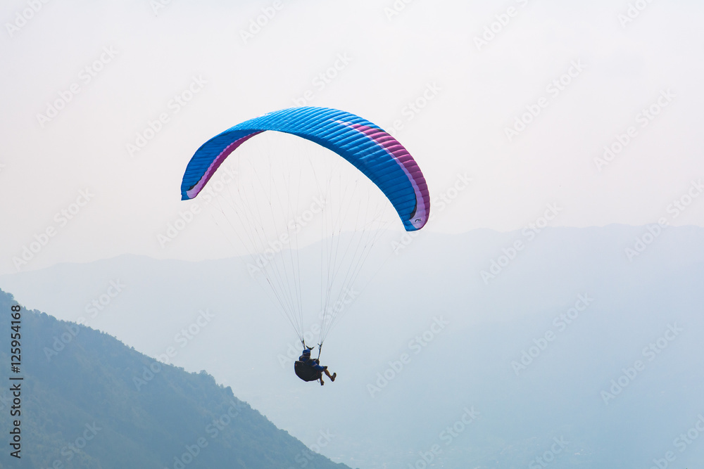 Paraglider flight over the mountains Paraglider flight over the mountains