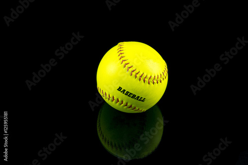 Baseball yellow on a black background .