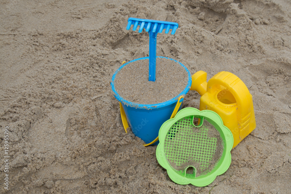 Child's toys on sandy beach, summer holidays concept Child's toys on sandy beach, summer holidays concept