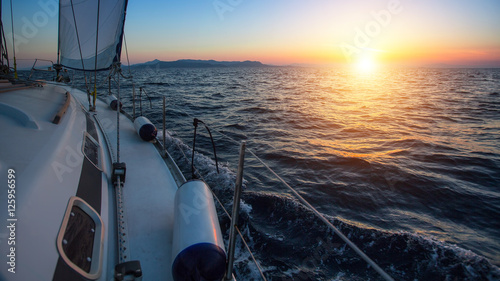 Φωτογραφία Sailing boat in the sea during a beautiful sunset.
