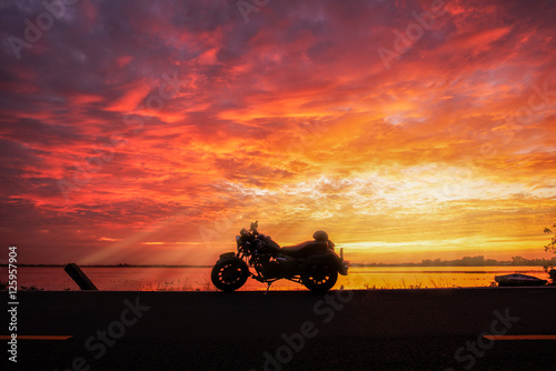 A silhouette big bike in sunset . © paejar