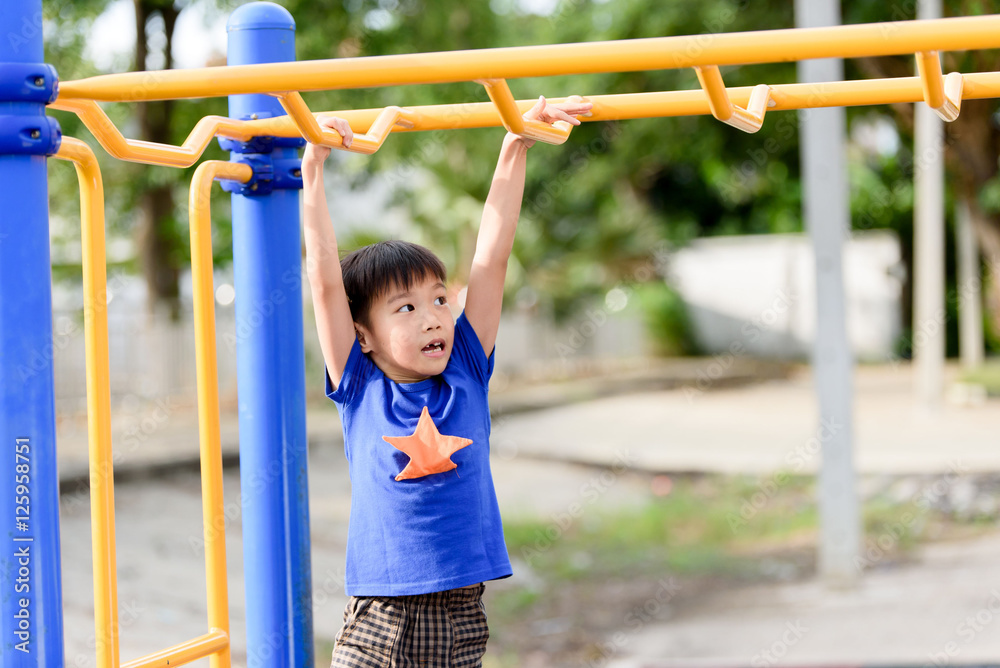 Young boy play with yellow bar Young boy play with yellow bar