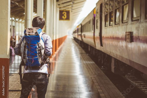 Traveler with backpack in train station. © bongkarn