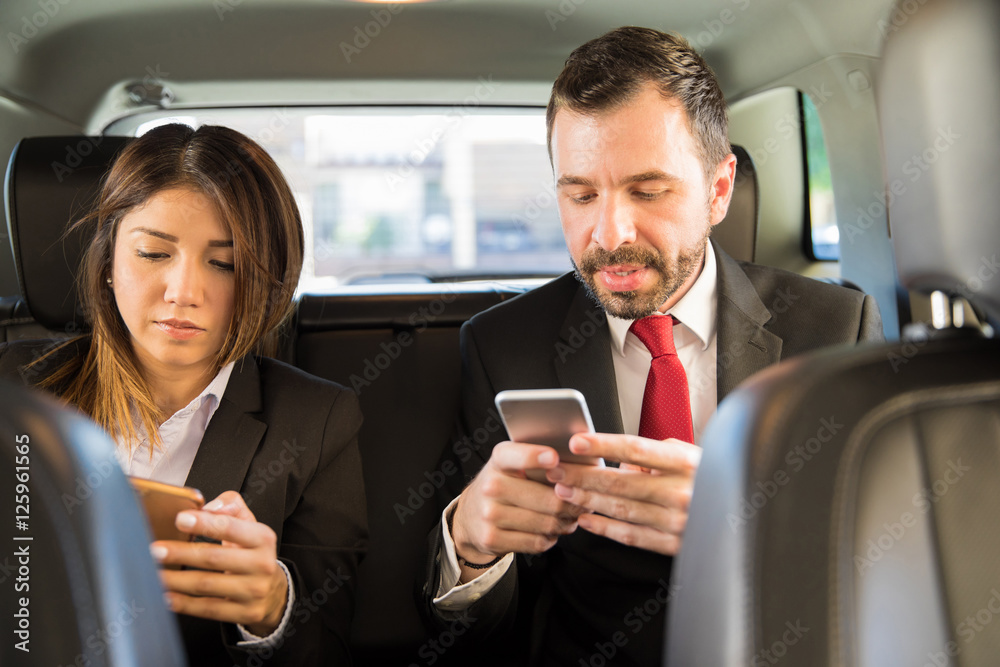 Businesspeople using their smartphones Businesspeople using their smartphones