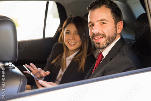 Businessman and woman working in a car © AntonioDiaz