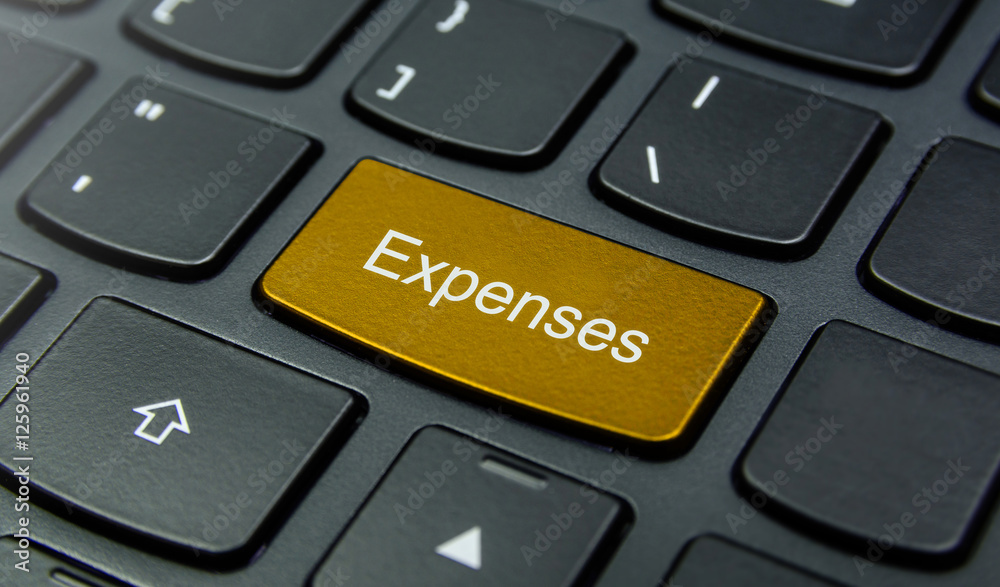Business Concept: Close-up the Expenses button on the keyboard and have Gold, Yellow color button isolate black keyboard Business Concept: Close-up the Expenses button on the keyboard and have Gold, Yellow color button isolate black keyboard