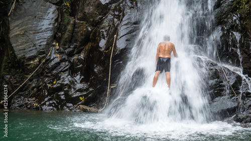 Man under a waterfall