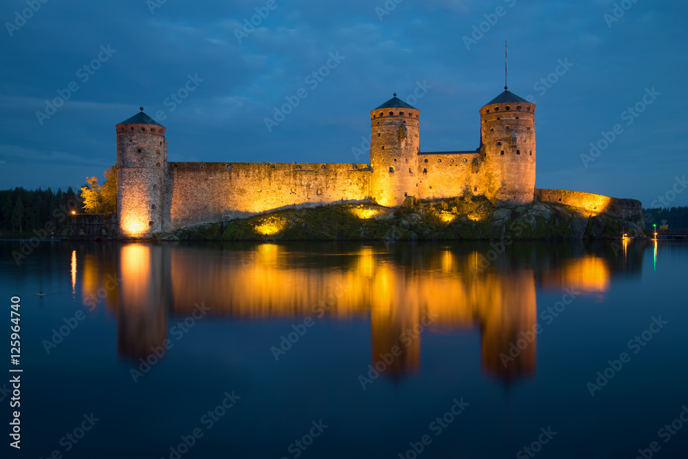 View of towers of Olavinlinn fortress in August night. Savonlinna, Finland