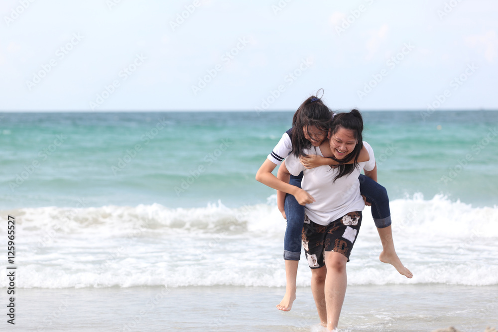 two Sister  playing on the beach at the day time. Concept Brother And Sister Together Forever