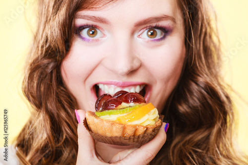 Closeup woman face and fruit cake