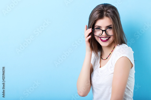 Young beautiful smiling girl in stylish glasses.