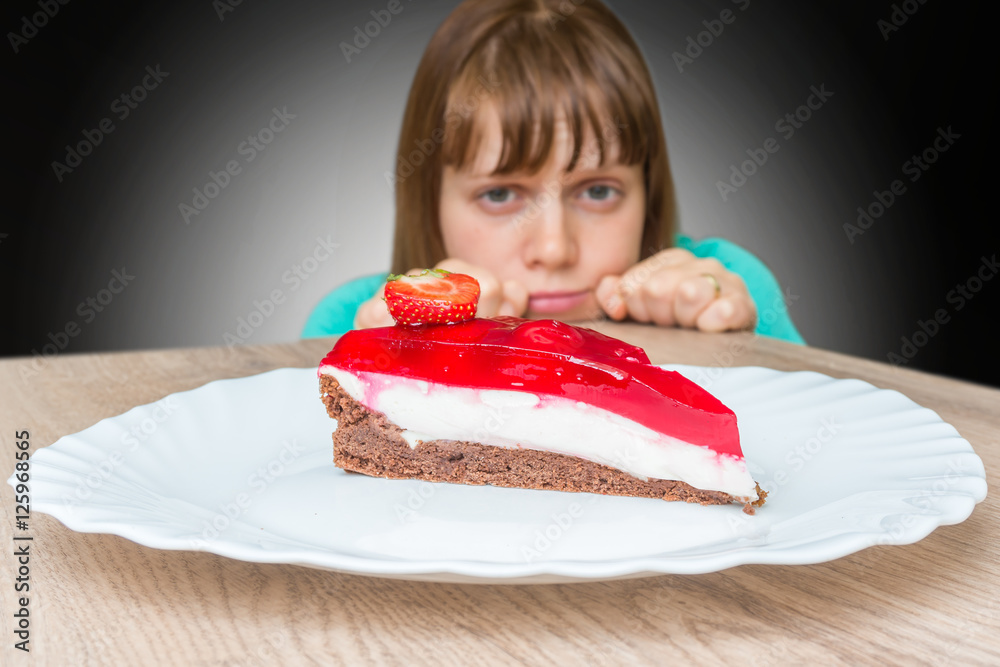Woman cannot resist the temptation and wants to eat sweet cake