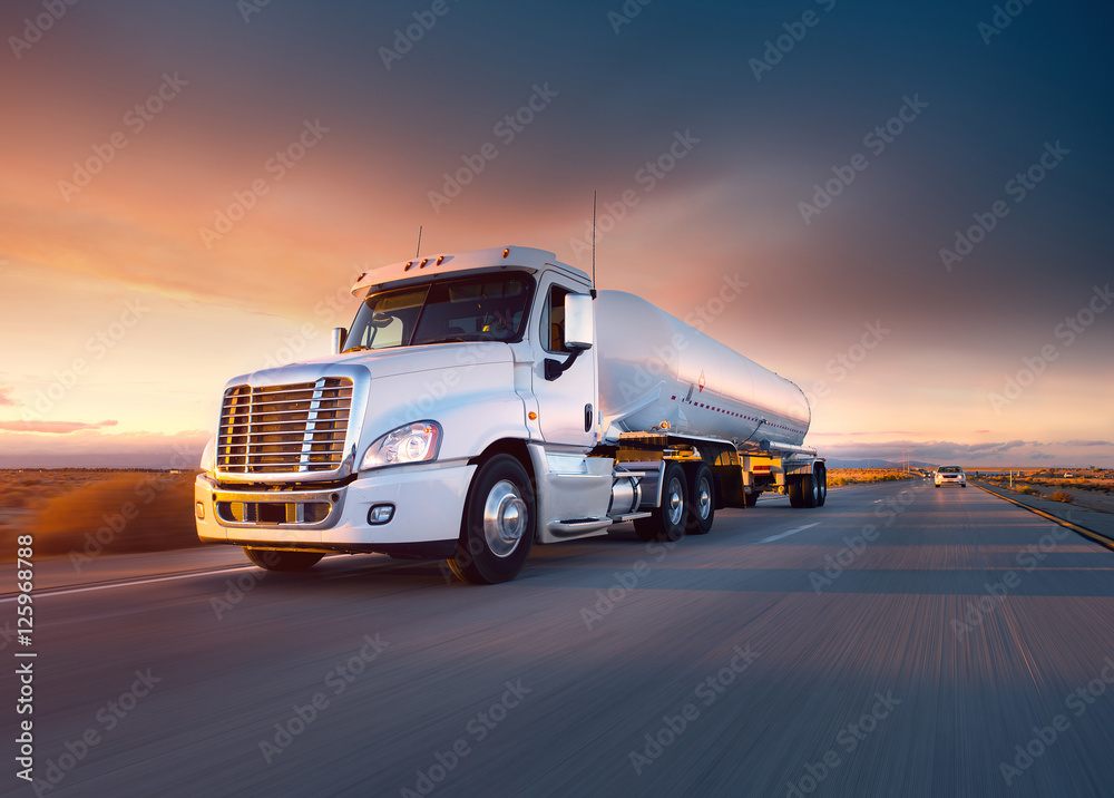 Truck cistern and highway at sunset - transportation background