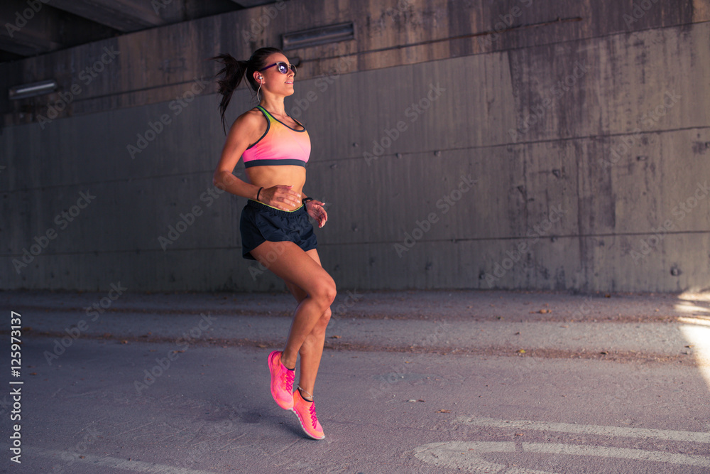 Fototapeta premium Fit woman runner warming up outdoors