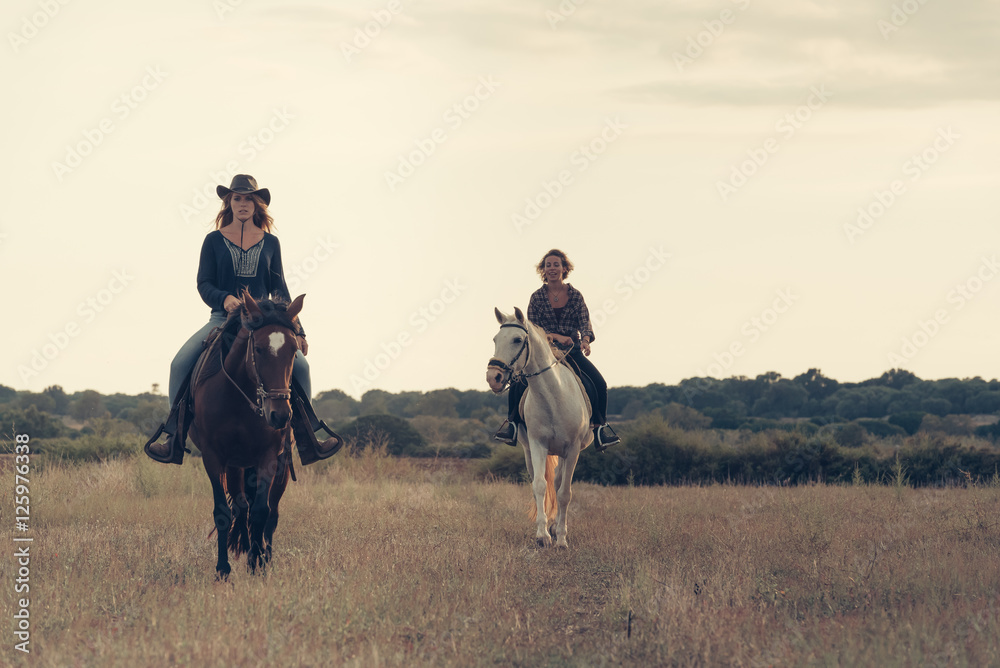 Girls Riding Horses in the Plains Mallorca Girls Riding Horses in the Plains Mallorca