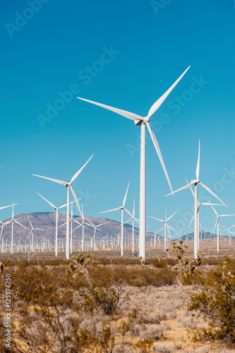 Wind turbines on a windfarm in California USA.  Vertical landscape with a wind turbines.