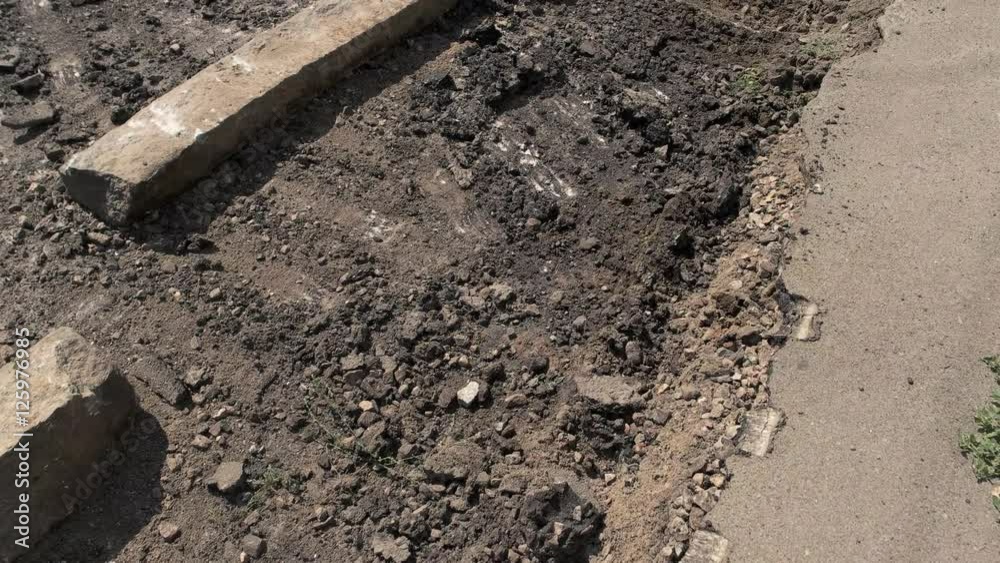 Damage of road surface. Concrete pieces on the ground. Dust and dirt. City roads need capital repair. Damage of road surface. Concrete pieces on the ground. Dust and dirt. City roads need capital repair.