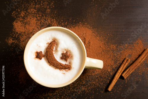 Cup of coffee with moon and stars pattern of cinnamon