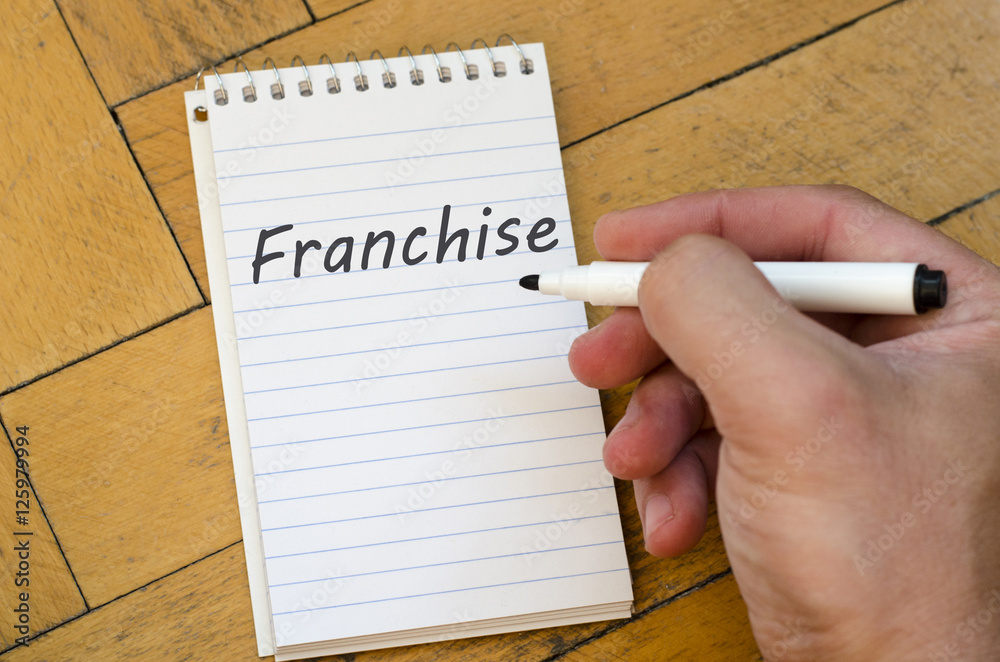 Franchise text concept on notebook Franchise text concept on notebook