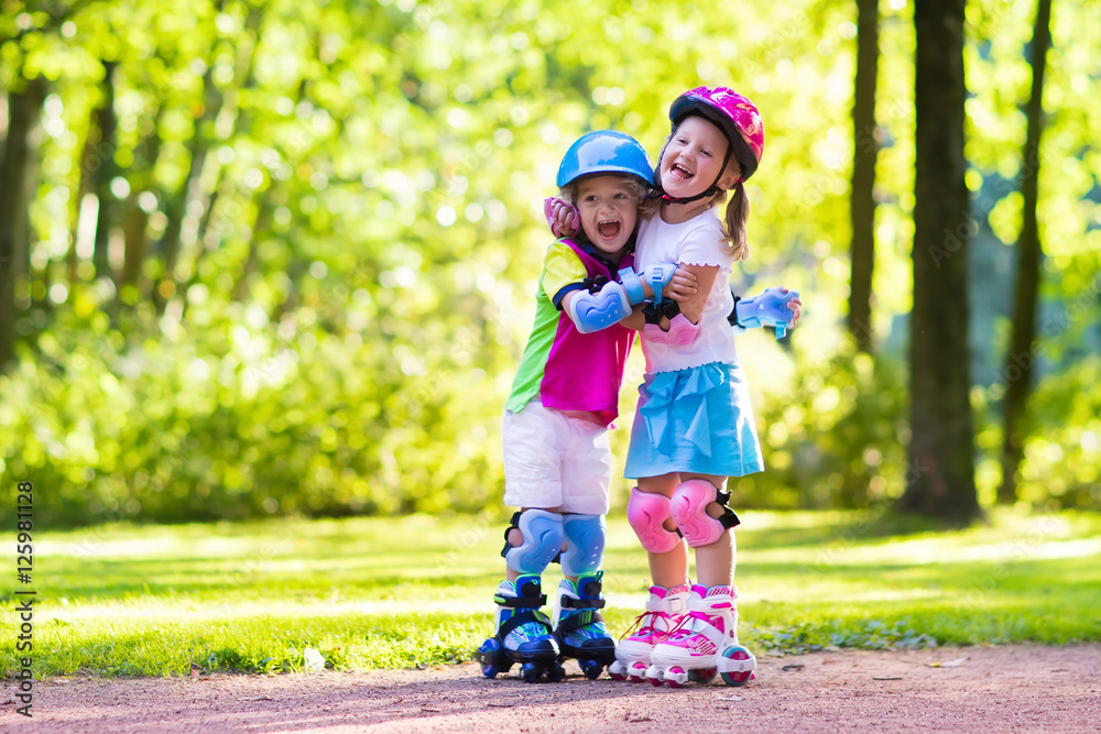 Kids roller skating in summer park Kids roller skating in summer park