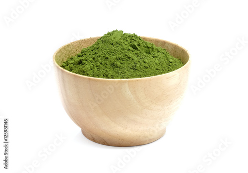 Green tea powder in wood bowl on white background.