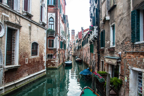 Water canal in venice with boats in Italy