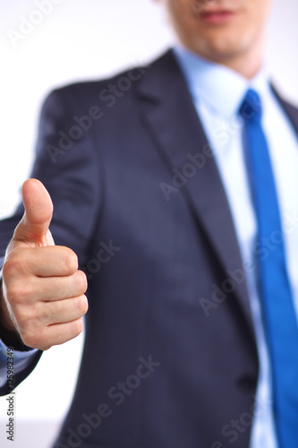 businessman with papers holds out his hand for a handshake