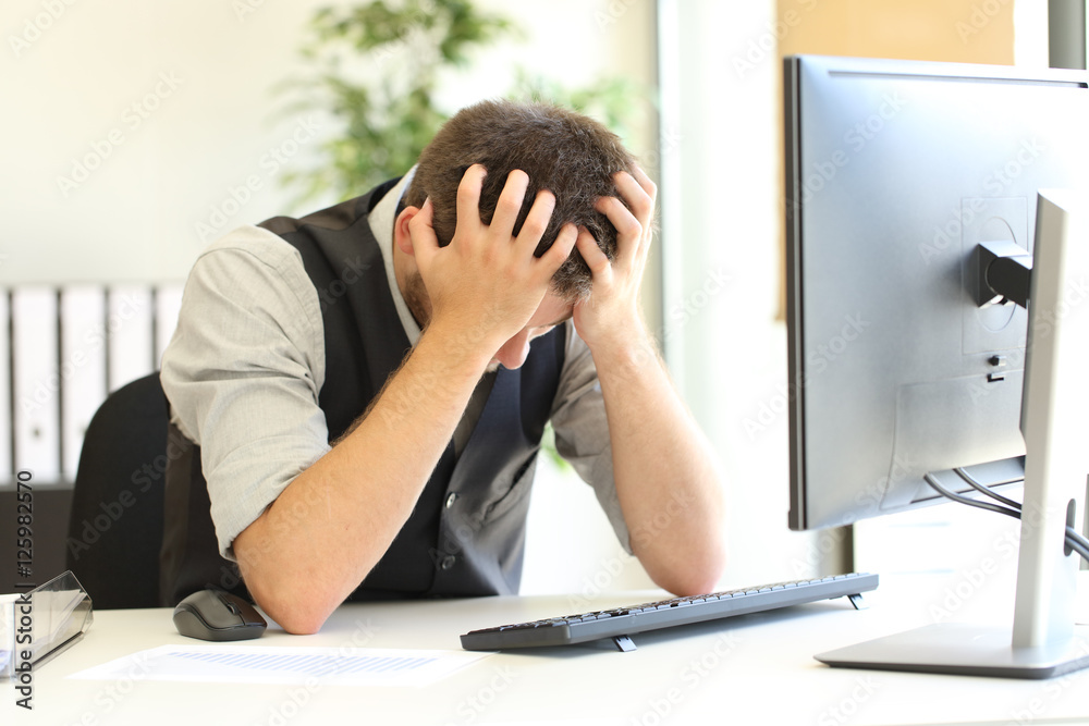Depressed businessman after bankruptcy at office Depressed businessman after bankruptcy at office