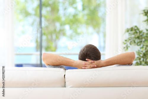 Free Download Man relaxed on a couch at home - GFXLoad